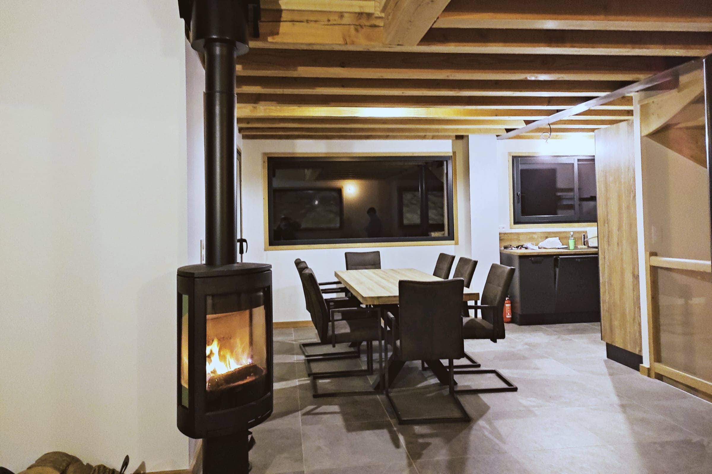 Le poêle allumé un soir d'hiver, la table dressée derrière